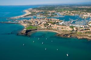 an aerial view of a harbor with boats in the water at Hotel & Spa Gil de France Cap d'Agde in Cap d'Agde