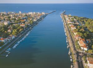 an aerial view of a river with a city at Hotel & Spa Gil de France Cap d'Agde in Cap d'Agde