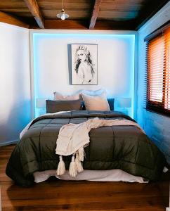 a bedroom with a large bed in a blue room at Daylesford - FROG HOLLOW ESTATE - One bedroom Homestead Villa - book for 3 nights pay for 2 - contact us for more details in Daylesford