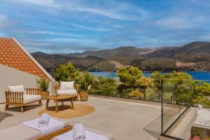 a patio with a view of the water and mountains at Veranda Suite in Argostoli