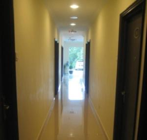 a hallway of a house with a hallway leading to a door at GM Holiday Hotel in Lumut