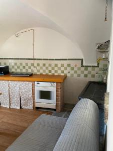 a kitchen with a counter and a stove top oven at Casa di Alvise in Lauco