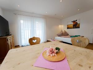 a room with a wooden table with a flower on it at Ferienwohnung Landliebe in Ravensburg