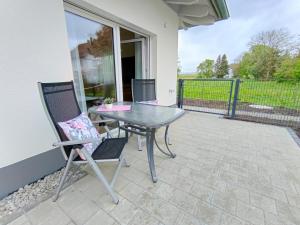 a table and two chairs on a patio at Ferienwohnung Landliebe in Ravensburg