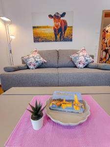 a table with a book on top of a couch at Ferienwohnung Landliebe in Ravensburg
