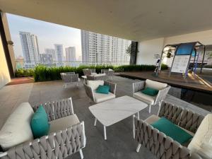 a patio with chairs and tables and a view of a city at Urban Suites Georgetown New Condo City View 158 in Jelutong