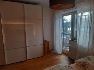 a bedroom with a bed and a large window at Ferienwohnung Goldeckblick in Seeboden