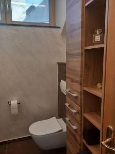 a bathroom with a white toilet and a window at Ferienwohnung Goldeckblick in Seeboden