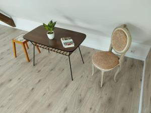 una mesa con 2 sillas y una mesa con una planta en Loft Apartment am Bahnhof, en Albstadt