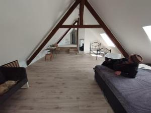 a person sitting on a couch in a loft at Loft Apartment am Bahnhof in Albstadt