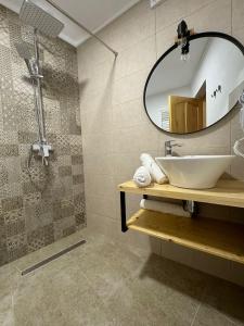 a bathroom with a sink and a mirror at B'LEK SEA RESORT in 2 Mai