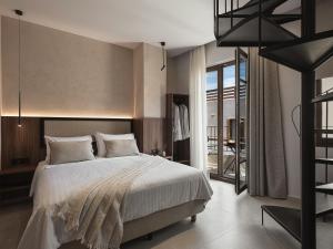 a bedroom with a large bed and a balcony at Copal Simple Staying in Chania