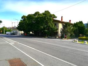 an empty street in front of a building at Coretti Rooms in Trieste