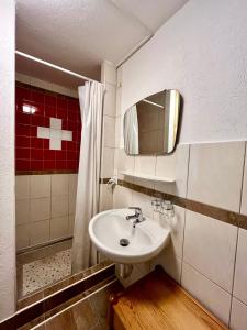 a bathroom with a sink and a mirror at Holiday House Lärchenheim in Saas-Balen