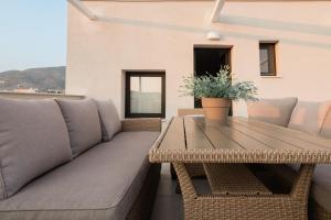 a living room with a couch and a table at ESTEA Quality Living in Volos