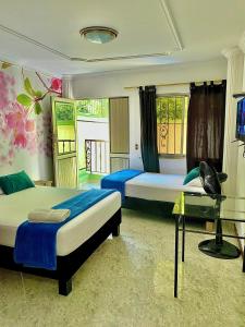 Postel nebo postele na pokoji v ubytování Casa Hotel Impacto