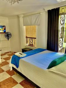 Postel nebo postele na pokoji v ubytování Casa Hotel Impacto