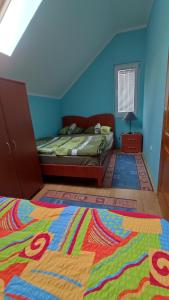 a bedroom with a bed and a colorful rug at Apartment Dobra vila in Perućac