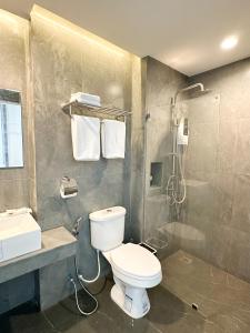a bathroom with a toilet and a sink and a shower at Mekong pano villa in Nakhon Phanom