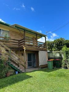 a house with a deck on the side of it at Sunshine Rooms in Maroochydore