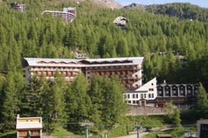 a large building on the side of a mountain at Stylish three rooms in Cervinia 82 in Breuil-Cervinia