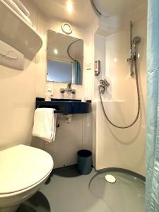a bathroom with a toilet and a sink and a shower at Fasthotel Toulouse Blagnac A&eacute;roport in Blagnac
