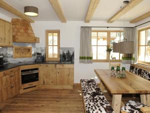 a kitchen with wooden cabinets and a wooden table at Great chalet in an idyllic location in Wagrain in Wagrain