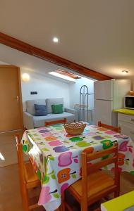 a dining room with a table and a kitchen at Casa Evita in Sanxenxo