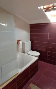 a bathroom with a white tub and a toilet at Casa Evita in Sanxenxo