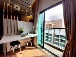 a kitchen with a table and a large window at Symphony Tower Studio #9 with balcony in Cheras