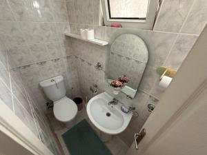 a bathroom with a toilet and a sink and a mirror at 2 bedroom apartment with sea view in Kyrenia centre in Kérynia +14 photos