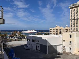 a view of a building and a cruise ship at 2 bedroom apartment with sea view in Kyrenia centre in Kérynia