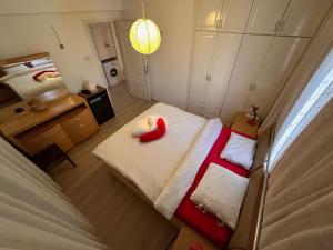 a bedroom with a bed with a stuffed animal on it at 2 bedroom apartment with sea view in Kyrenia centre in Kérynia
