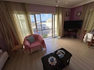 a living room with a view of a balcony at 2 bedroom apartment with sea view in Kyrenia centre in Kérynia