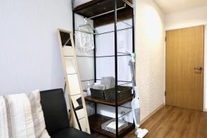 Zimmer mit Bücherregal und Bett in der Unterkunft Apartment Susukino Hakuhou Building in Sapporo