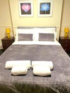 a bedroom with a bed with two pillows on it at Gravesend 1 bedroom Apartment in Kent