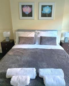 a bedroom with a bed with two towels on it at Gravesend 1 bedroom Apartment in Kent