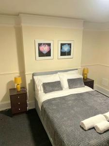 a bedroom with a large bed with two night stands at Gravesend 1 bedroom Apartment in Kent