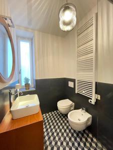 a bathroom with a toilet and a sink at LaViDaViò Suite Room in Bergamo +23 photos