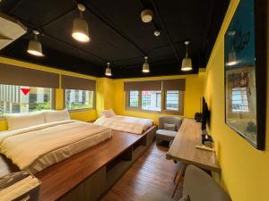 a bedroom with a large bed and a desk at Bon Hotel Taipei in Taipei