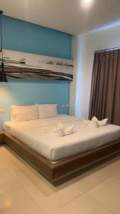 a large bed in a room with at Hotel The Journey Patong New in Patong Beach