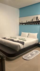 a bedroom with a large bed in a room at Hotel The Journey Patong New in Patong Beach