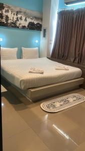 a large bed in a room with a mattressvisor at Hotel The Journey Patong New in Patong Beach