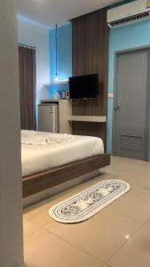 a bedroom with a bed and a flat screen tv at Hotel The Journey Patong New in Patong Beach