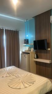 a hotel room with a bed and a flat screen tv at Hotel The Journey Patong New in Patong Beach