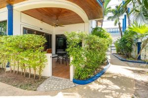 カマラビーチにある4-5 bedroom Villa At Kamala Beach, Poolの前に木々の入ったポーチのある家