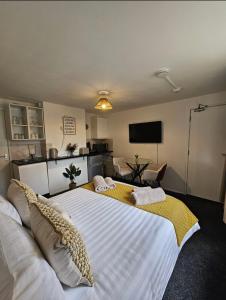 a bedroom with a large white bed with pillows on it at Stylish Studio Stevenage in Stevenage