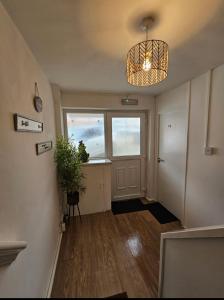a hallway with a door and a potted plant at Stylish Studio Stevenage in Stevenage