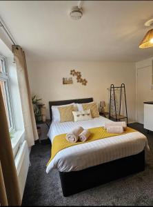 a bedroom with a large bed with pillows on it at Stylish Studio Stevenage in Stevenage