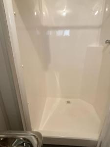 un bagno con box doccia bianco e lavandino. di Lyndhurst hotel SA 